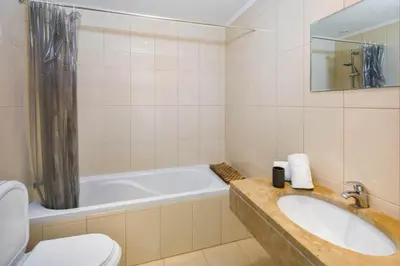 a bathroom with a tub and a sink and a toilet at Townhouse Flores in Faro