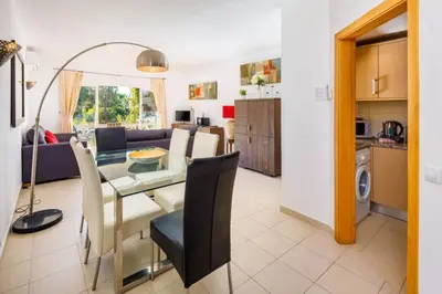 a dining room and kitchen with a table and chairs at Townhouse Flores in Faro