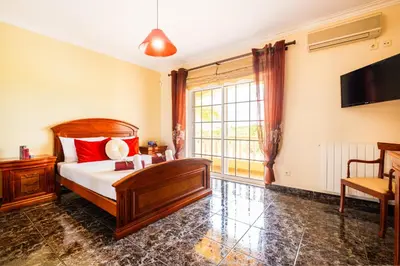 a bedroom with a bed and a large window at Villa Dubai by Algarve Vacation in Albufeira