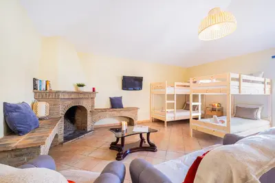 a living room with a fireplace and bunk beds at Villa Dubai by Algarve Vacation in Albufeira