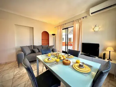 a living room with a table and a couch at Vilamoura Central 8 by Homing in Vilamoura