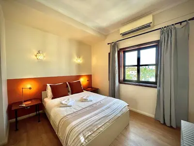 a bedroom with a large bed and a window at Vilamoura Central 8 by Homing in Vilamoura
