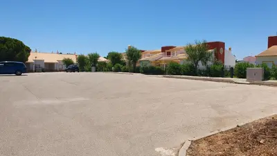 an empty parking lot with a car parked in a driveway at Villa Falésia casa da Sobreira in Albufeira