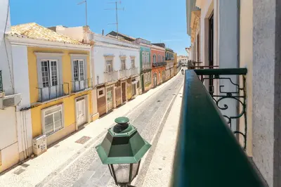 a view from a balcony of a street with buildings at Blife Alicya private rooms in Faro