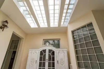 a skylight in a room with a door and windows at Blife Alicya private rooms in Faro
