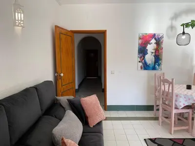 a living room with a couch and a table at The Albufeira Concierge - Pool ChoroMar Apartment in Albufeira