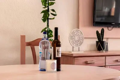 a kitchen with white cabinets and a microwave at The Albufeira Concierge - Pool ChoroMar Apartment in Albufeira