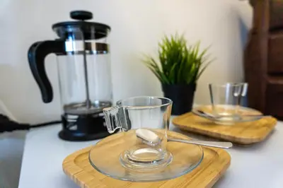 two glasses on a cutting board with a blender at Aconchego de quartos no centro de Faro in Faro