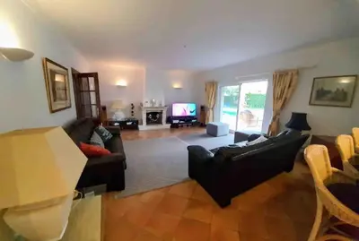 a living room with a couch and a tv at Luxury Private 5 bedroom Villa pool, golf, Algarve in Quarteira
