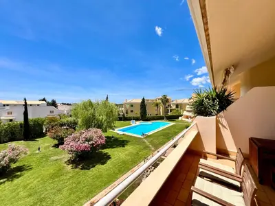 a view from the balcony of a house with a swimming pool at Home Out - Vilamoura Beach Apartment - Duplex in Quarteira