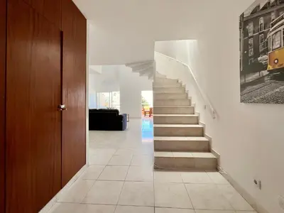 a hallway with a staircase in a house at Home Out - Vilamoura Beach Apartment - Duplex in Quarteira