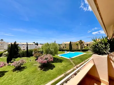 a view of a yard with a swimming pool at Home Out - Vilamoura Beach Apartment - Duplex in Quarteira