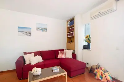 a living room with a red couch and a table at Apartarment Azur in Albufeira