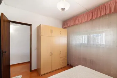 a bedroom with a bed and a cabinet and a window at Apartarment Azur in Albufeira