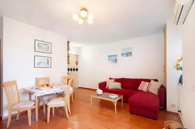 a living room with a red couch and a table at Apartarment Azur in Albufeira