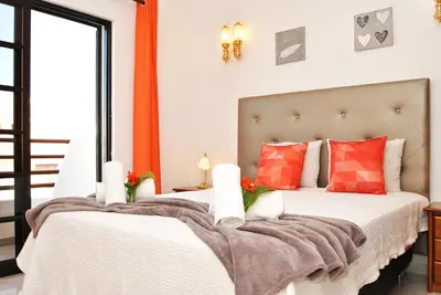 a bedroom with two beds with red pillows at Villa Ibiza by Algarve Vacation in Guia