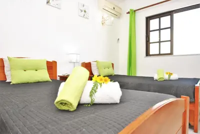 a bedroom with a large bed with flowers on it at Villa Ibiza by Algarve Vacation in Guia