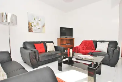 a living room with two couches and a tv at Villa Ibiza by Algarve Vacation in Guia