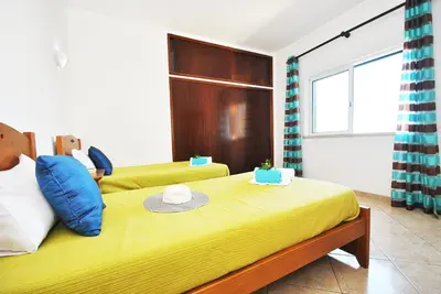 a bedroom with a yellow bed with a hat on it at Villa La Romana by Algarve Vacation in Albufeira
