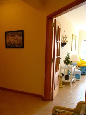 a living room with an orange wall and a door at Calm Sunny Apartment near Falésia Beach in Albufeira
