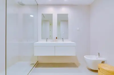 a white bathroom with a sink and a mirror at AL - Villas Country Club in Vilamoura