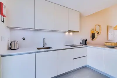 a white kitchen with white cabinets and a sink at AL - Villas Country Club in Vilamoura