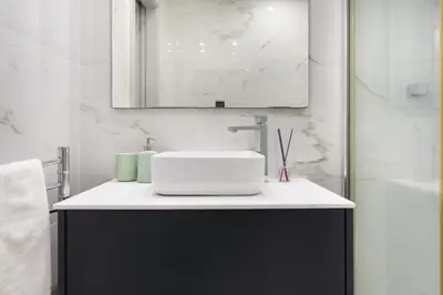 a bathroom with a white sink and a mirror at ALICE - Vilamoura in Vilamoura