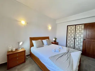 a bedroom with a bed with two towels on it at Albufeira Tropical View 1 With Pool by Homing in Albufeira