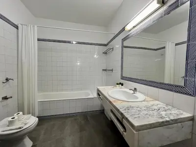 a bathroom with a sink and a tub and a toilet at Albufeira Tropical View 1 With Pool by Homing in Albufeira