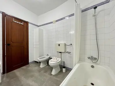 a bathroom with a toilet and a tub and a sink at Albufeira Tropical View 1 With Pool by Homing in Albufeira