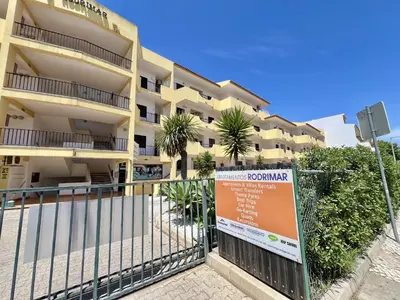 a building with a sign in front of it at Albufeira Tropical View 1 With Pool by Homing in Albufeira