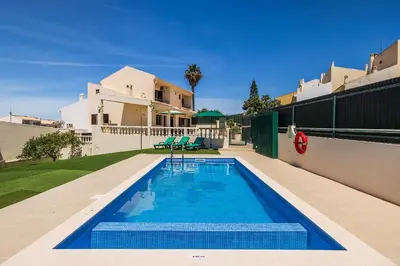 a swimming pool in the backyard of a house at Villa Krishan Albufeira - Private Pool in Albufeira