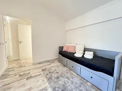a bedroom with a bed with two shoes on it at Albufeira Stylish 3 by Homing in Albufeira