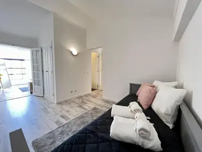 a bedroom with a bed with white and pink pillows at Albufeira Stylish 3 by Homing in Albufeira