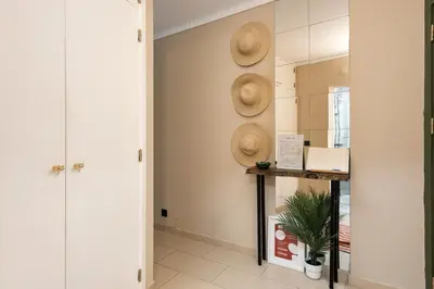 a hallway with straw hats on the wall at Dona Marieta House in Vilamoura