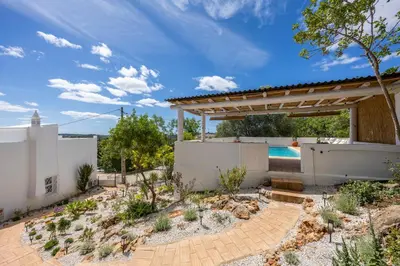 a backyard with a pool and a pavilion at Casa Ladeira in Loulé