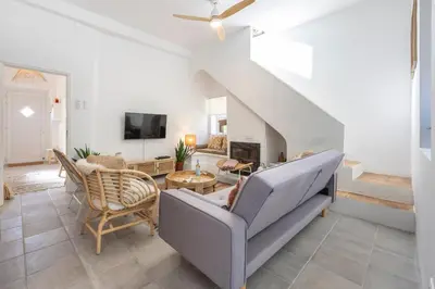 a living room with a couch and a table at Casa Ladeira in Loulé