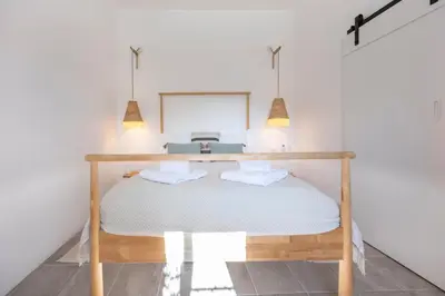 a bedroom with a bed with a table on it at Casa Ladeira in Loulé