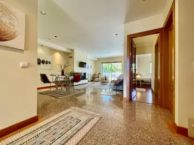 an open living room with a dining room at Casa Falésia - 150 meters from Falésia Beach in Albufeira