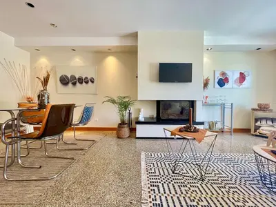 a living room with a table and chairs at Casa Falésia - 150 meters from Falésia Beach in Albufeira