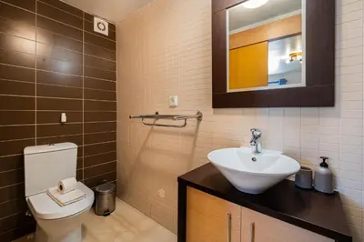 a bathroom with a white toilet and a sink at Daisy 2 Bedroom Apartment in Albufeira