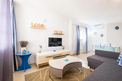 a living room with a couch and a table at Daisy 2 Bedroom Apartment in Albufeira