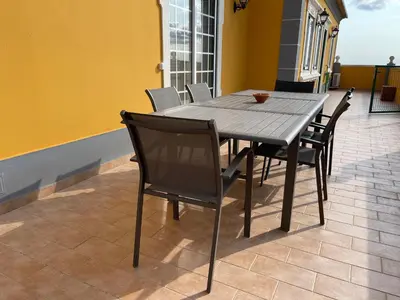 a black dining table and chairs on a patio at AL Monte Lusitano in Loulé