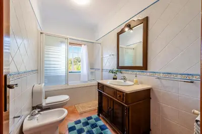 a bathroom with a sink and a toilet and a mirror at AL Monte Lusitano in Loulé
