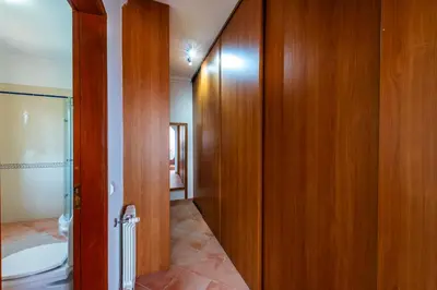 a bathroom with a toilet and a wooden door at AL Monte Lusitano in Loulé