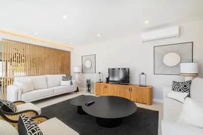 a living room with a white couch and a table at Valbom Luxury Village in Galé