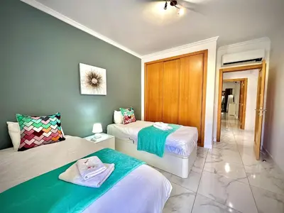 two beds in a room with green walls at Vilamoura Prestige 2 With Pool by Homing in Vilamoura
