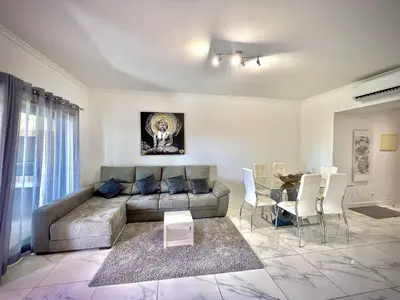 a living room with a couch and a table at Vilamoura Prestige 2 With Pool by Homing in Vilamoura
