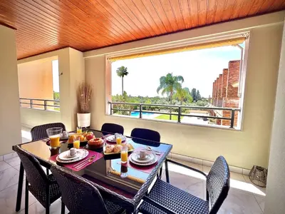 a dining room with a table and a large window at Vilamoura Prestige 2 With Pool by Homing in Vilamoura