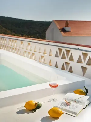 a dining room with tables and chairs and windows at Viceroy at Ombria Algarve in Loulé